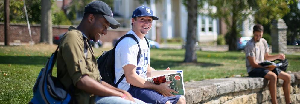 garrett brown and carlos sitting on wall outside smeal building at 365英国上市杜波依斯分校